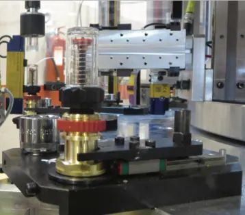 Screw driving spindle positioned over a brass component